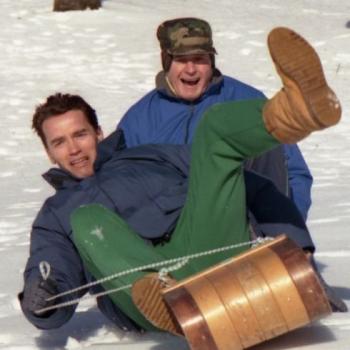 President Bush and Arnold Achwarzenegger sledding at Camp David