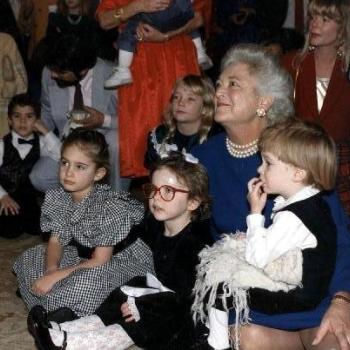 Mrs Bush sits on floor with grandchildren