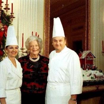 Barbara Bush stands next to gingerbread house with White House Pastry Chef Roland Mesnier