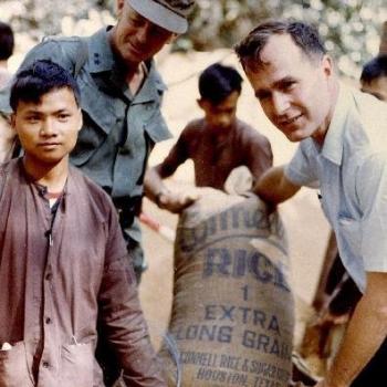 George Bush and Gen. F.K. Means Load Captured Viet Cong Rice