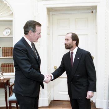 President Bush greets singer Lee Greenwood in the Oval Office