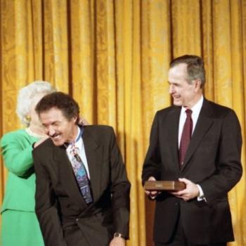 President and Mrs Bush award the Presidential Medal of Freedom to Nascar driver Richard Petty. Mrs Bush places the Medal around his neck.