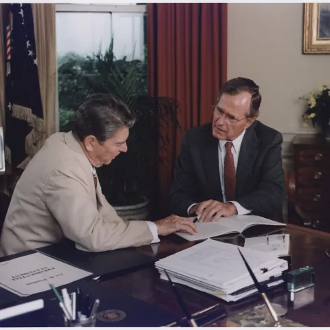 Vice President Bush and President Reagan working in the Oval Office