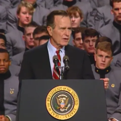 President George Bush stands at a podium