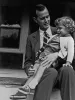 George H.W. Bush sits on porch with his young daughter in his lap