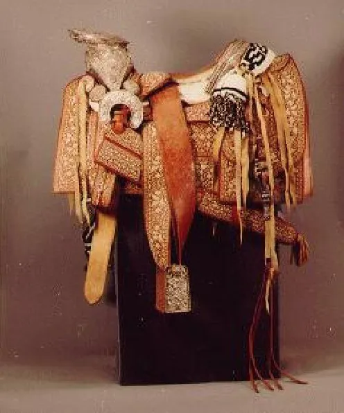 Tooled leather saddle embellished with silver repousse horn