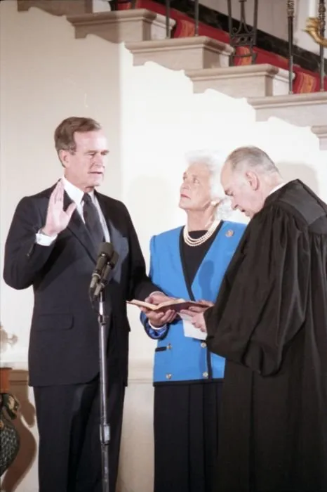 Supreme Court Justice Potter Stewart administers the Vice Presidential Oath of Office to Vice President George Bush as Mrs. Bush holds the Bible during a private swearing in ceremony at the White House