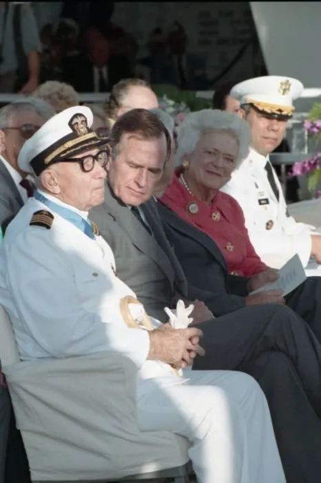 50th anniversary of the Japanese attack on Pearl Harbor, held at the USS Arizona Memorial. Seated with the President are Pearl Harbor Survivor, Captain Donald K. Ross (USN Retired), Mrs. Bush, General Colin Powell, and others.