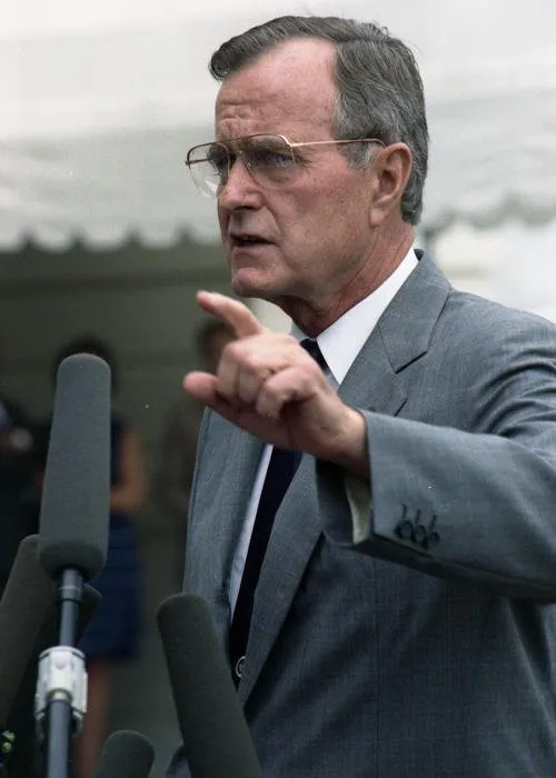 President Bush speaks to the press regarding Iraq's invasion of Kuwait; South Lawn of the White House