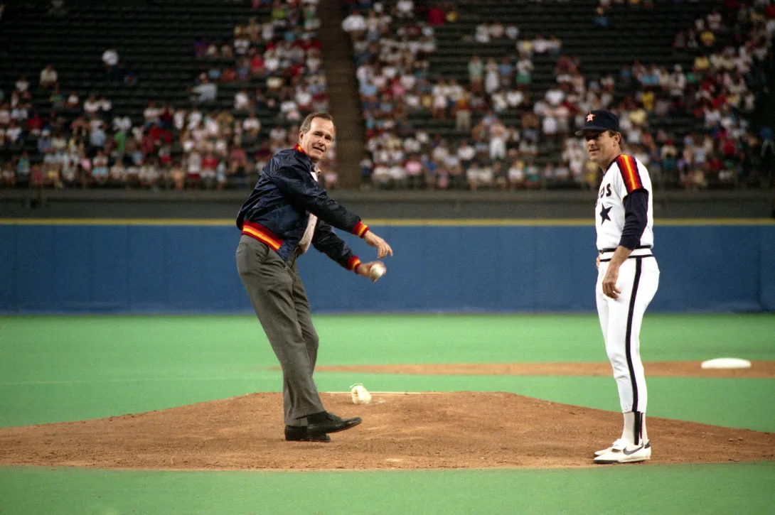 Vice President George Bush throws out the first pitch at the Astrodome as Astro's pitcher Nolan Ryan looks on