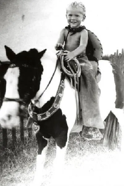 George W. Wearing a Cowboy Outfit as he Sits on a Pony