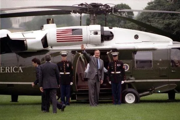 President Bush waves to crowd prior to boarding Marine One