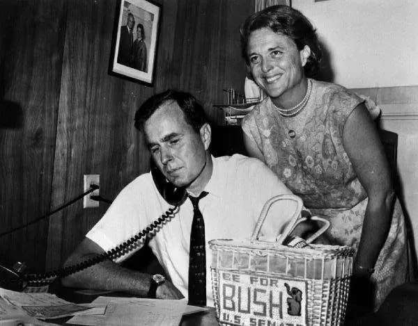 George Bush talks on the phone while Barbara Bush looks on, George Bush for Senate Headquarters