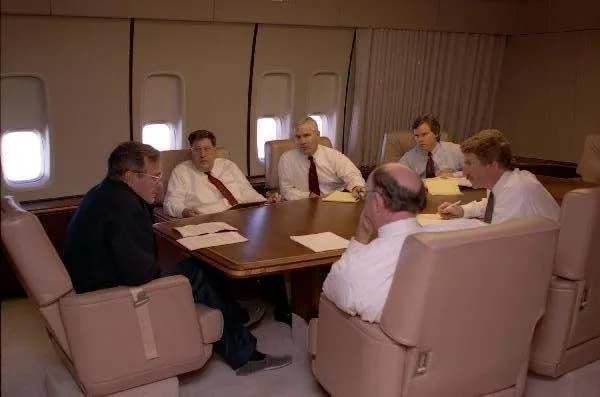 President Bush meets with staff on Air Force One during campaign swing to MA and FL