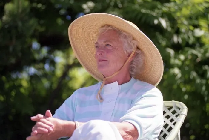 Mrs. Bush watches President Bush play doubles tennis with their son, Jeb, at Walker's Point, Kennebunkport, Maine