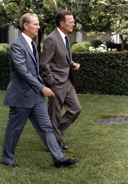 President Bush and Baker cross the South Lawn to speak to the press