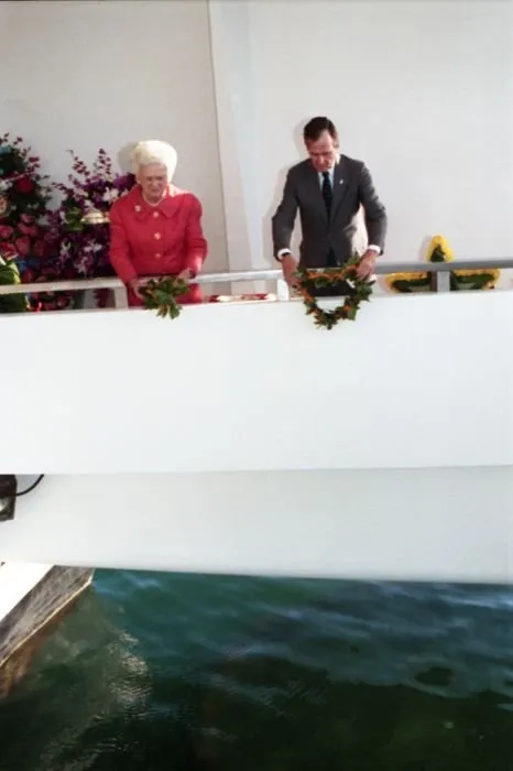 President and Mrs. Bush drop wreathes into the water from the aft of the USS Arizona Memorial as part of a ceremony commemorating the 50th anniversary of the Japanese attack on Pearl Harbor.