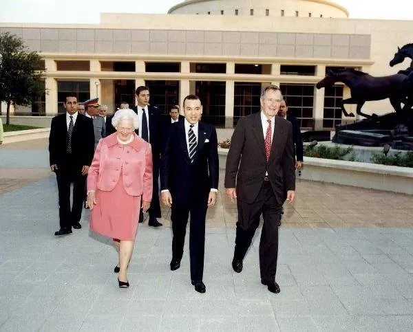 King Al Mamlakah Al Maghrihiyah of Morocco Walks with George and Barbara Bush