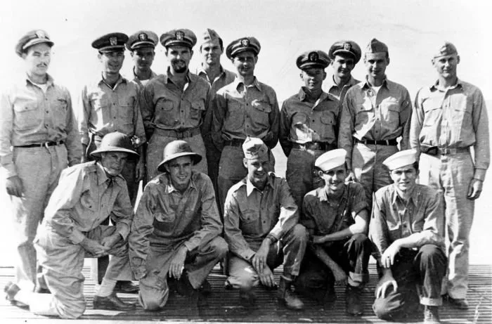 Aviators and crewmen rescued by the USS Finback during the first phase of Operation Stalemate II pose for a photo with officers of the USS Finback