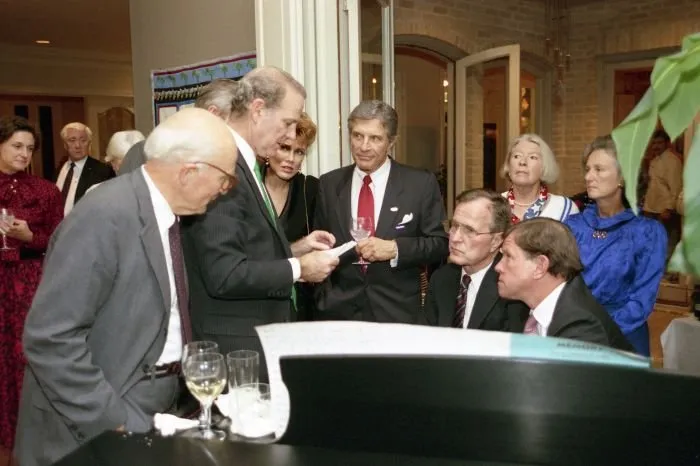 Vice President Bush discusses the election returns on TV with various family, friends and campaign staff in Houston, Texas