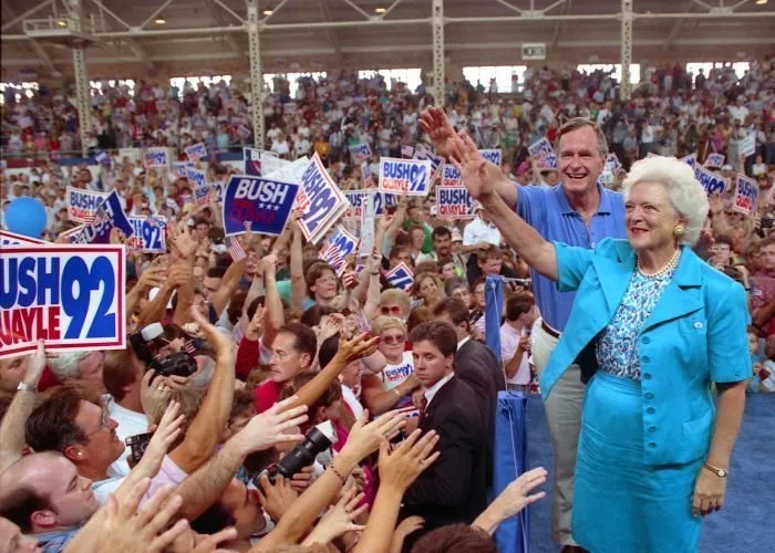 President Bush and Barbara Bush wave to supporters at a campaign stop at the Illinois Farm Exposition in Springield, Il