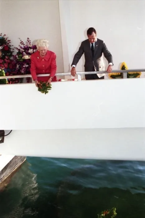 President and Mrs. Bush drop wreathes into the water from the aft of the USS Arizona Memorial as part of a ceremony commemorating the 50th anniversary of the Japanese attack on Pearl Harbor.