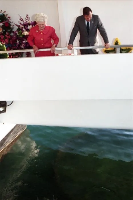 President and Mrs. Bush drop wreathes into the water from the aft of the USS Arizona Memorial as part of a ceremony commemorating the 50th anniversary of the Japanese attack on Pearl Harbor.