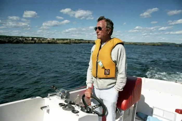 Vice President Bush drives his boat off the coast of his home on Walker's Point, Maine
