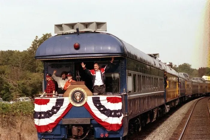 President Bush , Laura, Jenna, and Barbara Bush greet people along the train route from Norcross to Gainesville during the whistle-stop through Georgia