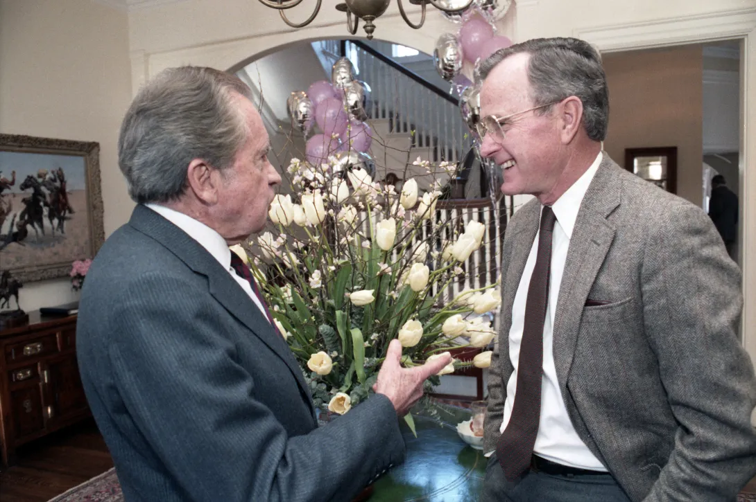 Vice President George Bush chats with former President Richard Nixon at a party for former special counsel to President Nixon, Dick Moore, held at the Vice President's Residence
