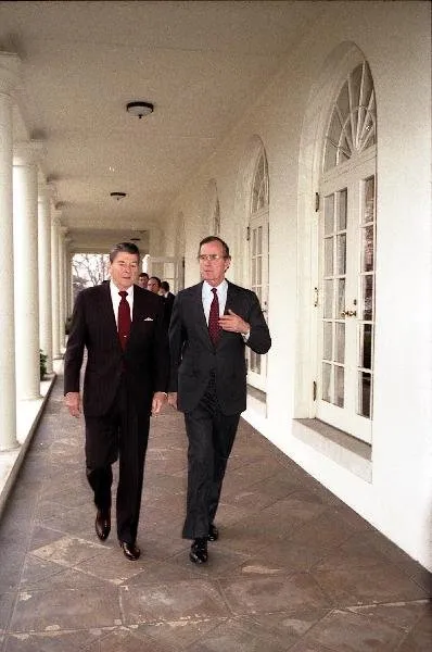 President Ronald Reagan and Vice President George Bush walk along the West Wing Colonnade