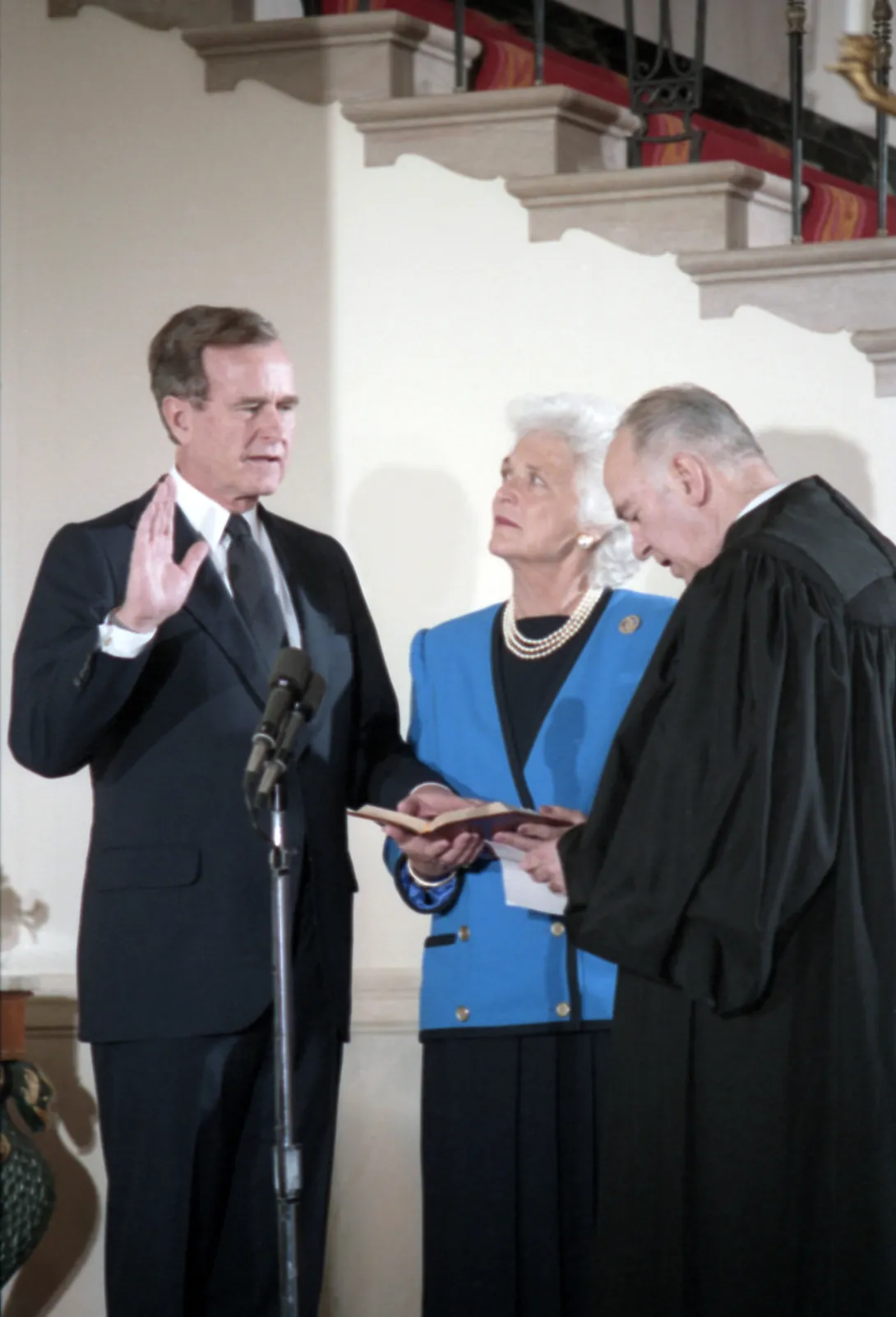 Supreme Court Justice Potter Stewart administers the Vice Presidential Oath of Office to Vice President George Bush as Mrs. Bush holds the Bible during a private swearing in ceremony at the White House