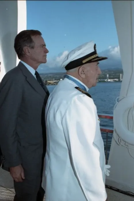 President Bush stands at attention with USS Nevada survivor and Medal of Honor recipient, Captain Donald K. Ross (USN Retired), during a ceremony at the USS Arizona