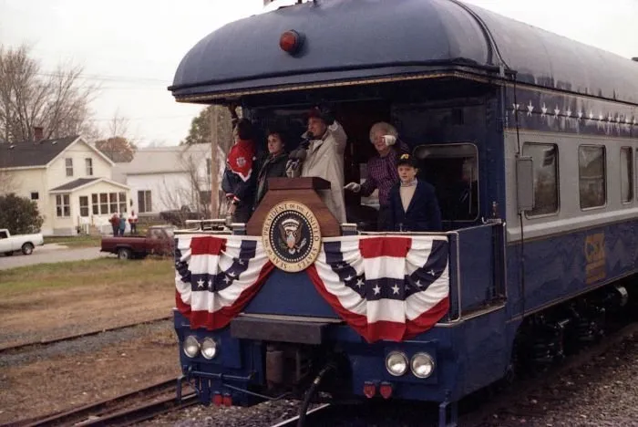 President Bush addresses supporters in Oshkosh, WI as Barbara Bush looks on