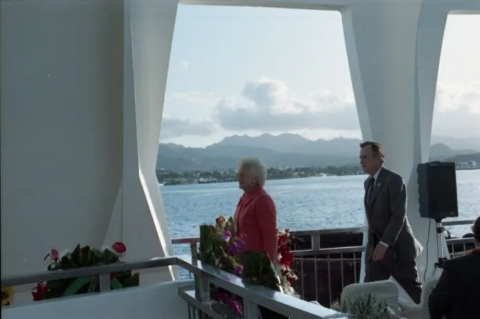 President and Mrs. Bush prepare to drop wreathes into the water from the aft of the USS Arizona Memorial