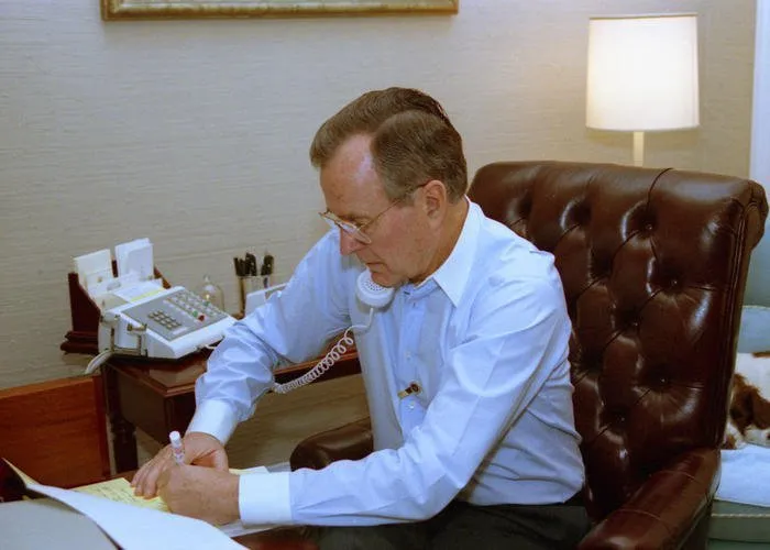 President Bush talks with Secretary Baker by telephone