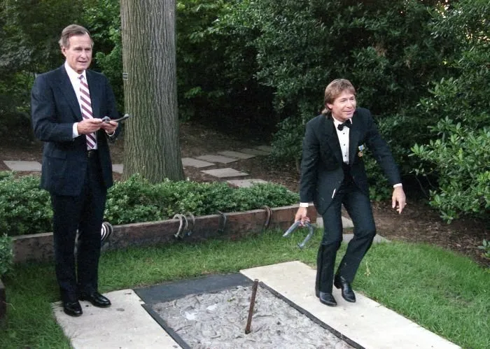 President Bush and John Denver pitch horseshoes