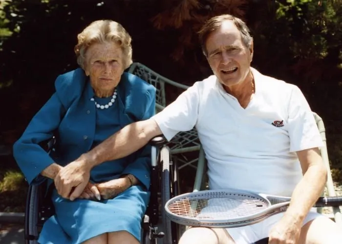President Bush takes a minute from playing tennis to visit with his mother