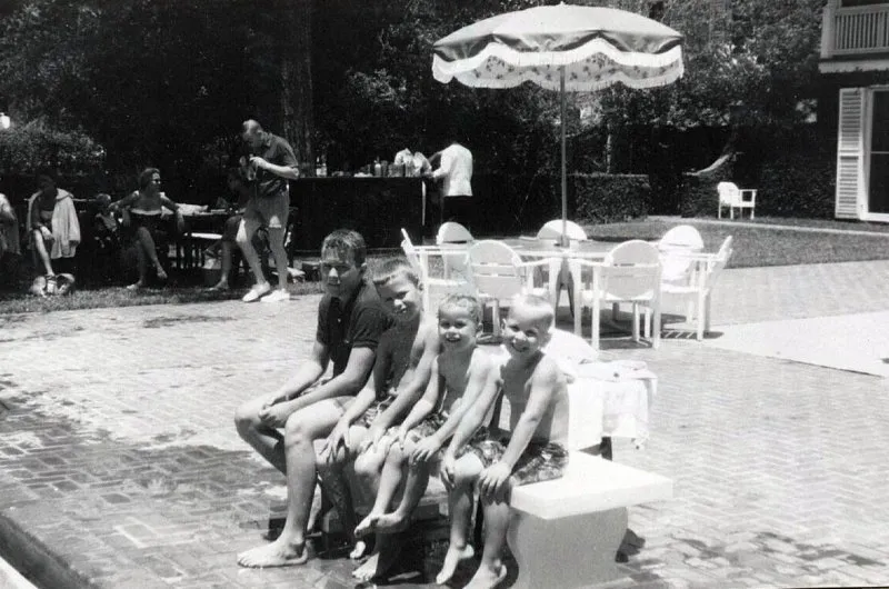 George W., Jeb, Marvin and Neil Bush on a diving board at the Bayou Club in Houston, Texas