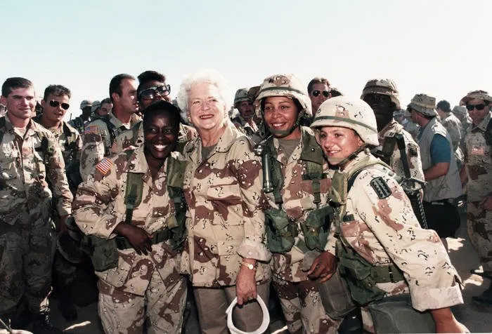 Mrs. Bush poses with a group of female soldiers during a Thanksgiving visit with the troops in Saudi Arabia