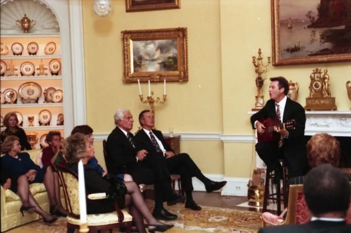 Country singer Larry Gatlin performs for President Bush and guests in the Yellow Oval Room