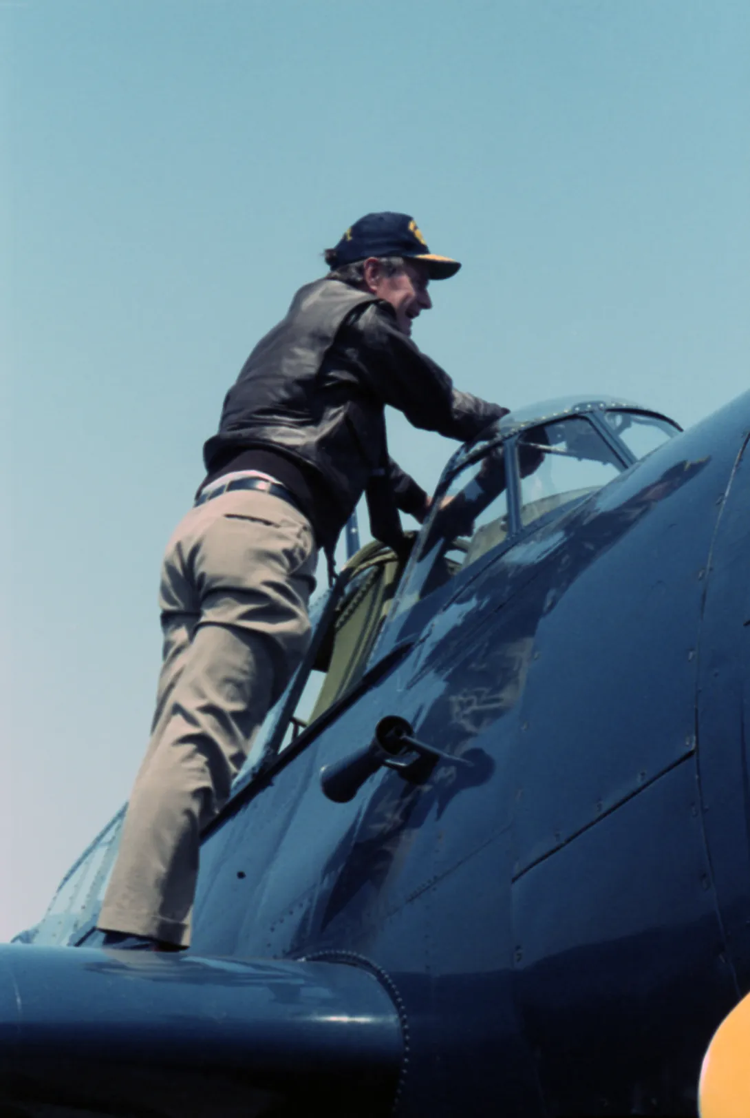 Vice President George Bush standing over the cockpit of an Avenger during an event at Naval Station Norfolk commemorating the 40th anniversary of the day his plane was shot down over the island of Chi Chi Jima