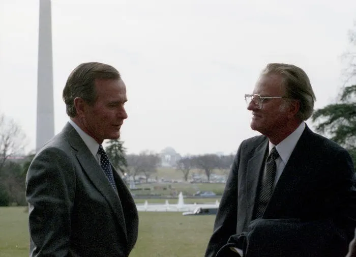 President Bush speaks with Rev. Billy Graham on the South Lawn of the White House after attending the National Prayer Breakfast at the Washington Hilton