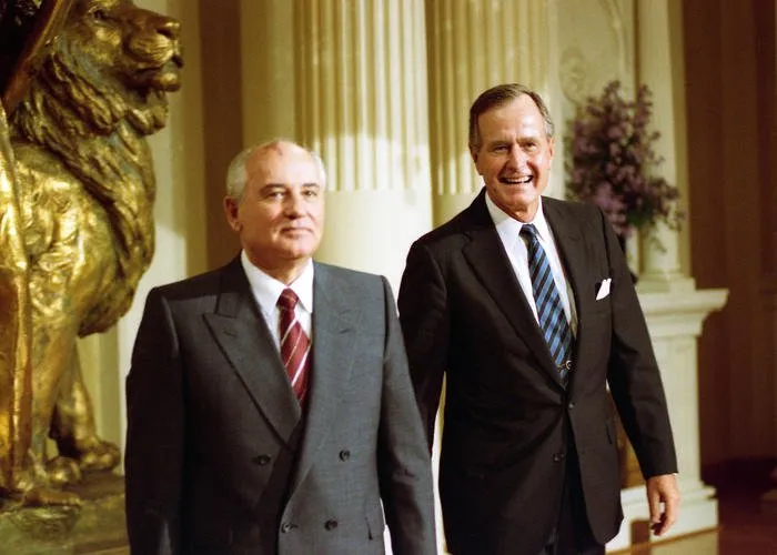 Presidents Bush and Gorbachev pose for a photo during their meeting in Helsinki, Finland