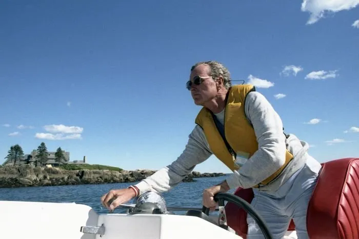 Vice President Bush drives his boat off the coast of his home on Walker's Point, Maine