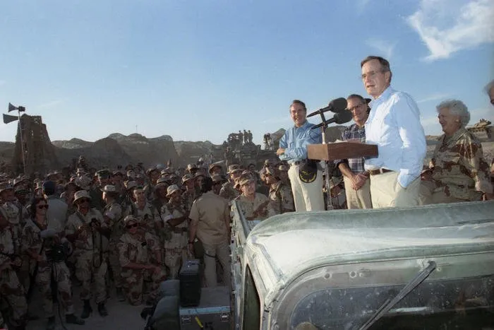 President and Mrs. Bush greet troops and have Thanksgiving dinner at the First Marine Division Command Post in Saudi Arabia
