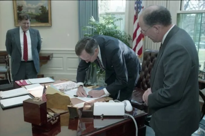 President Bush signs a baseball card for Arthur Shorin, President of Topps