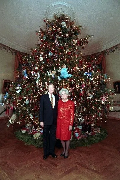 The Bushes pose in front of the 1989 White House Christmas Tree