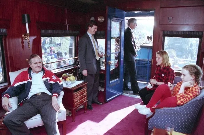 President Bush visits with his granddaughters, Jenna and Barbara, in his train car in Cornelia, Georgia