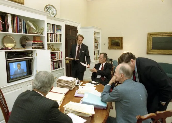 President Bush, Robert Gates, Gen. Scowcroft, Gov. Sununu, and Richard Haass watch an Iraqi spokesman on the television in Gen. Scowcroft's office